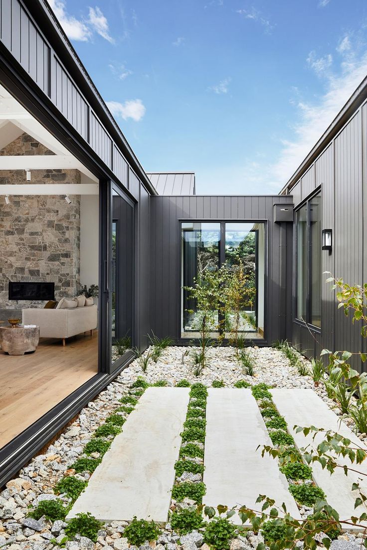 an outdoor courtyard with grass and rocks