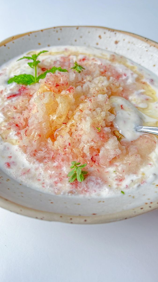 a white bowl filled with food on top of a table