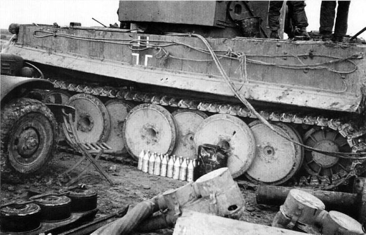 an old tank sitting on top of a dirt field