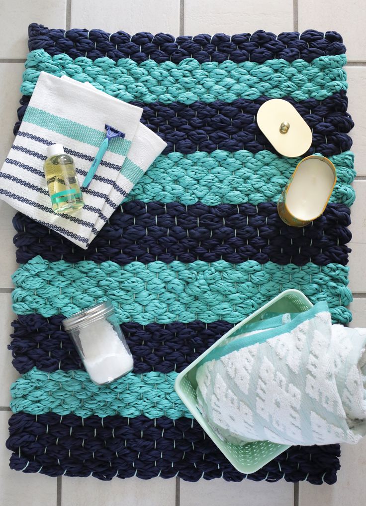 a blue and white place mat sitting on top of a tiled floor