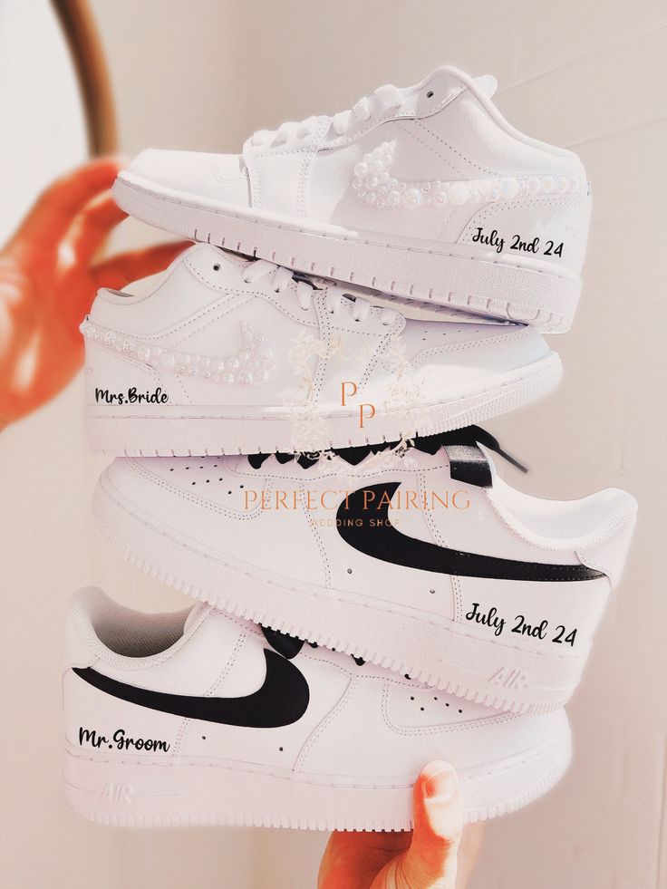 a person holding four pairs of nike air force 1s in their hand with the price label on them