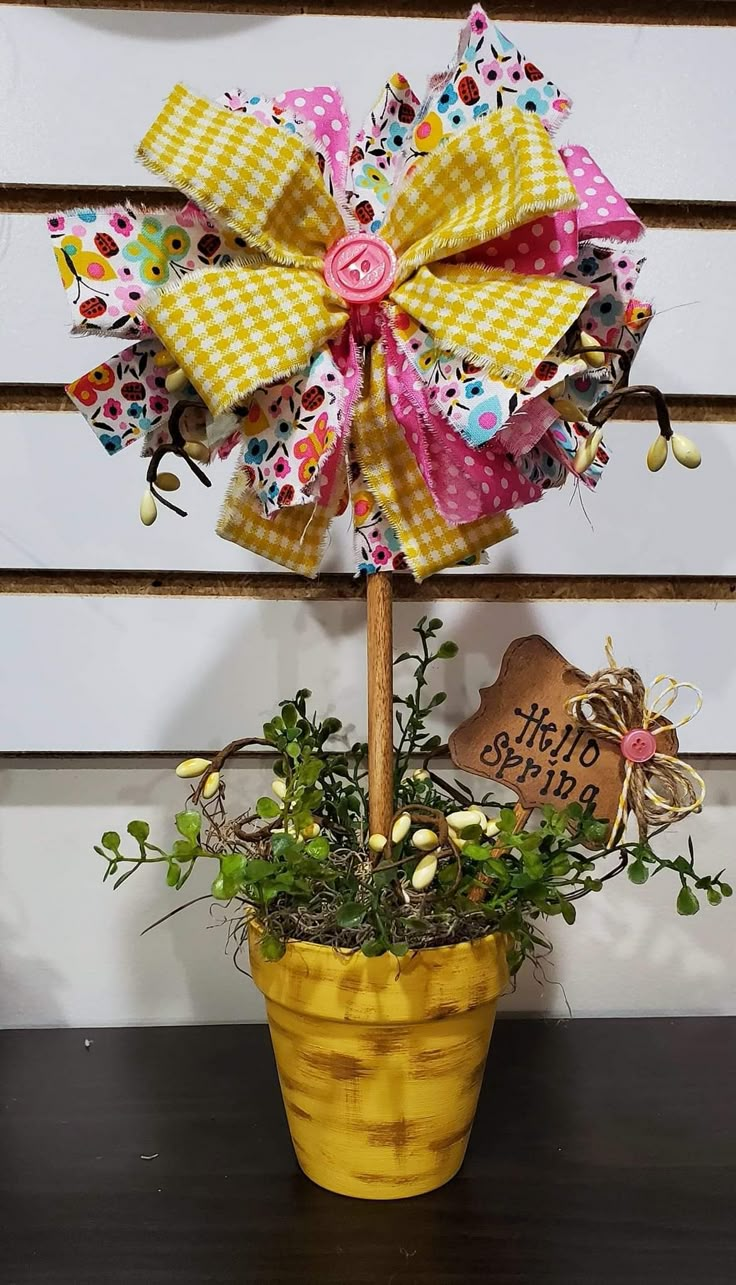 a potted plant with a yellow bow on it