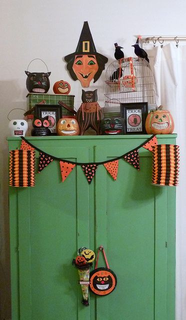 a green cabinet with halloween decorations on it