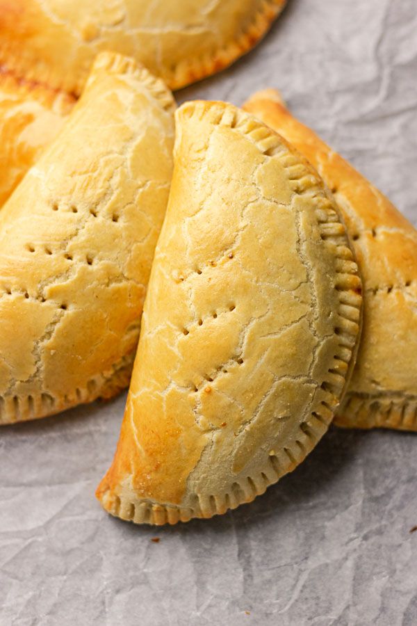 several pastries sitting on top of a piece of wax paper next to each other