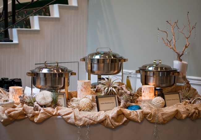 a table topped with pots and pans covered in burlap next to stairs