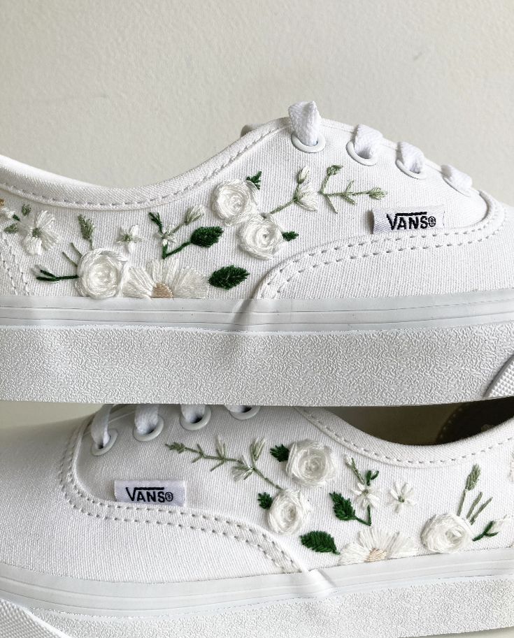 two white vans with flowers painted on them