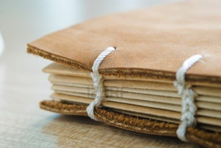 a stack of brown paper sitting on top of a wooden table