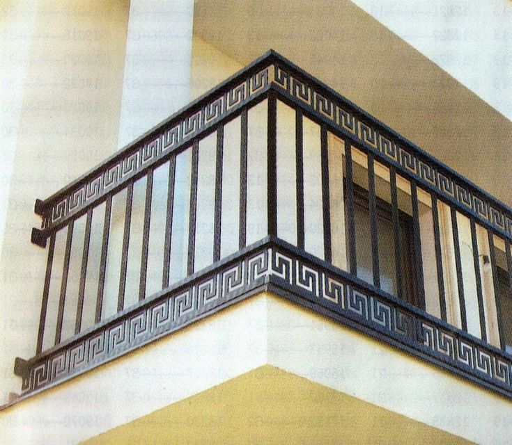 an iron balcony railing on the side of a building