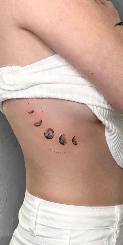 a woman's stomach with three planets on it