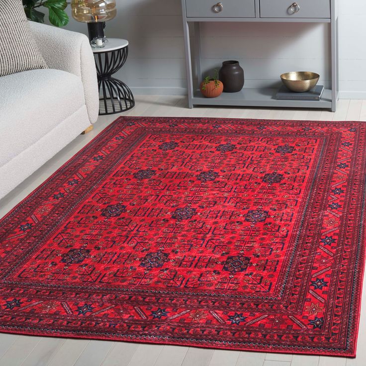 a large red rug in the middle of a room