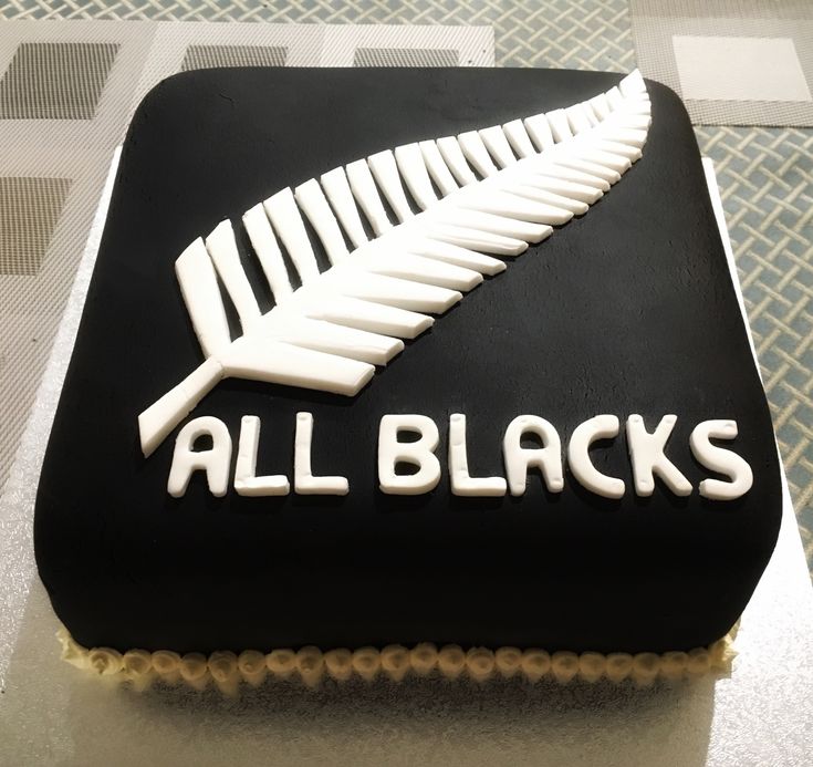 a black and white cake with the words all blacks on it's bottom layer