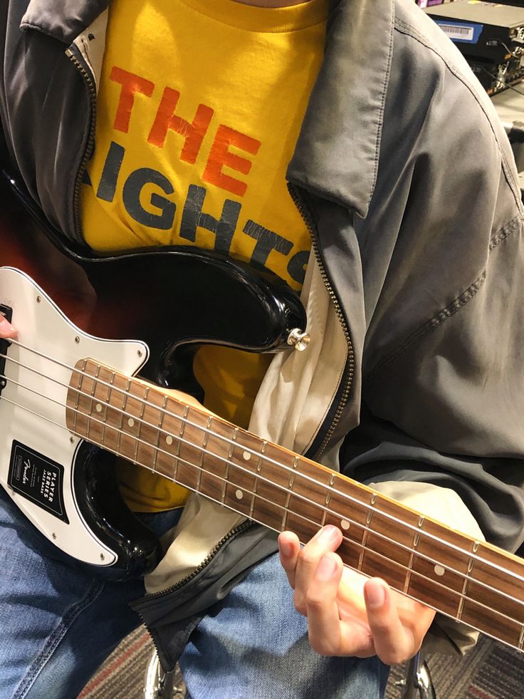 a young man is playing an electric guitar