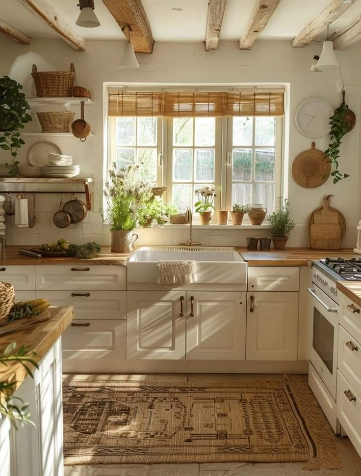 a kitchen filled with lots of white cabinets and counter top space next to a window