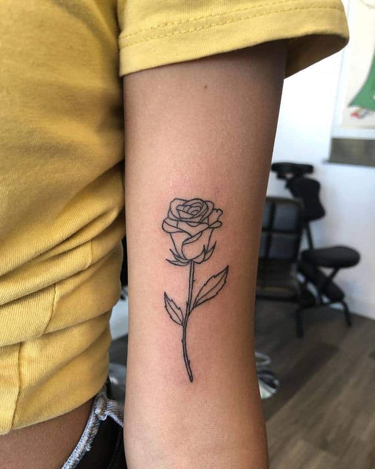 a single rose tattoo on the arm