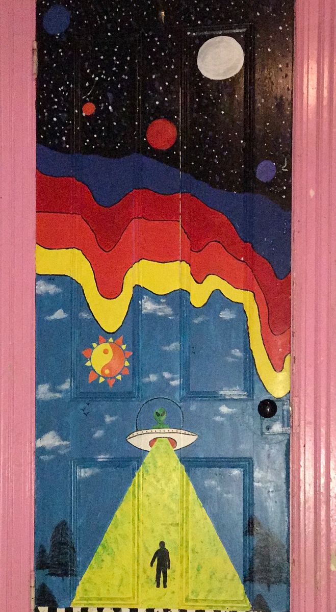 a door with an image of a man in the sky and planets painted on it