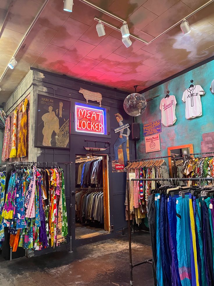 the inside of a clothing store with clothes on display