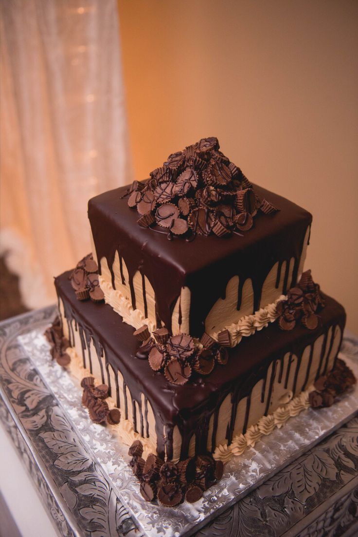 two tiered chocolate cake sitting on top of a table