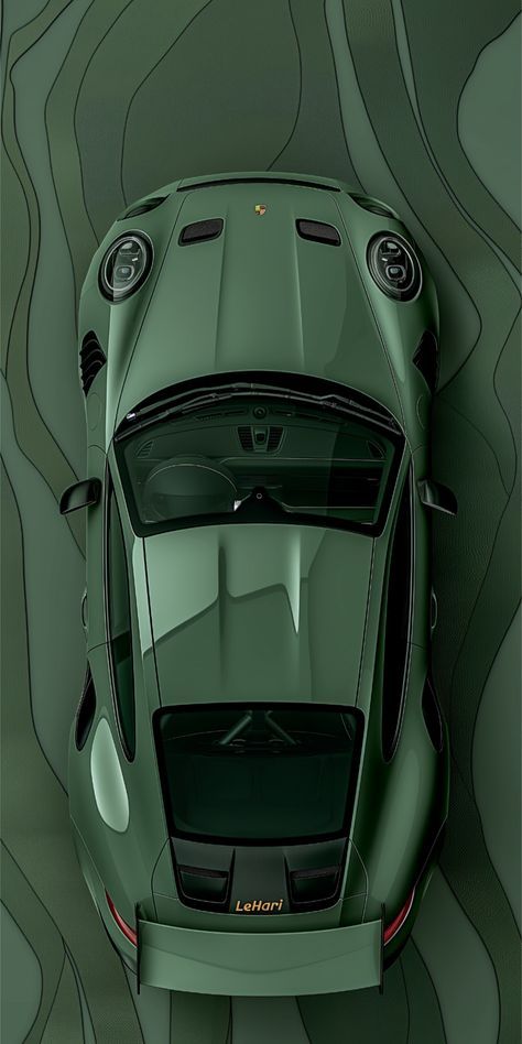 the top view of a green sports car in front of a wavy pattern wallpaper