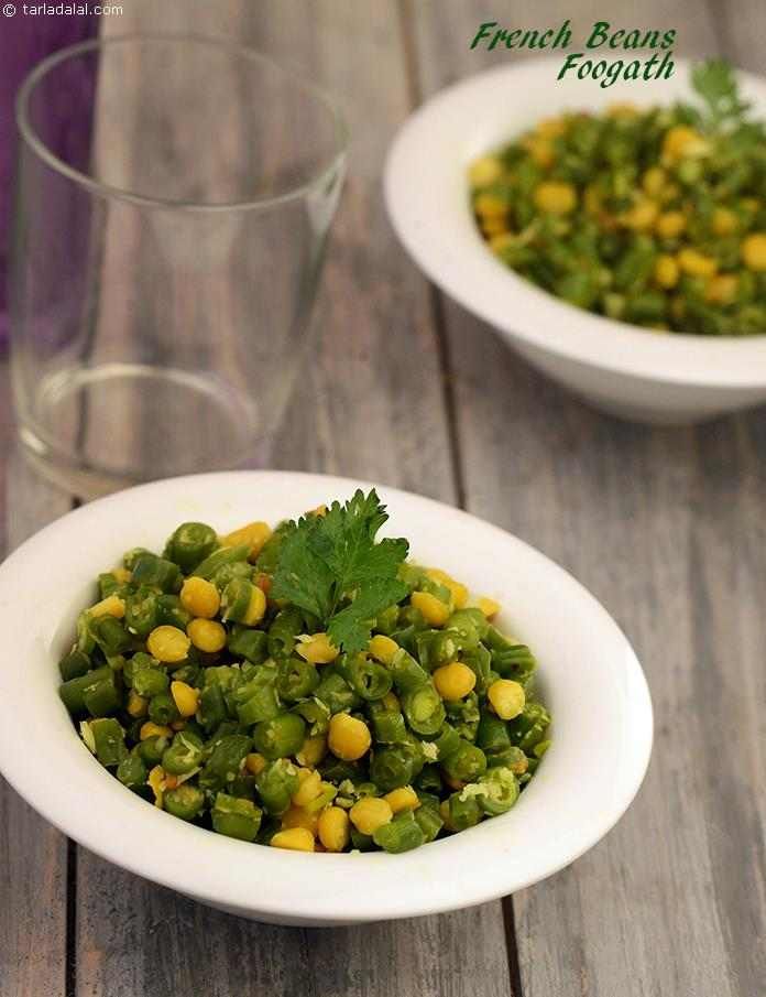 two white bowls filled with green beans and coriant garnished with cilantro