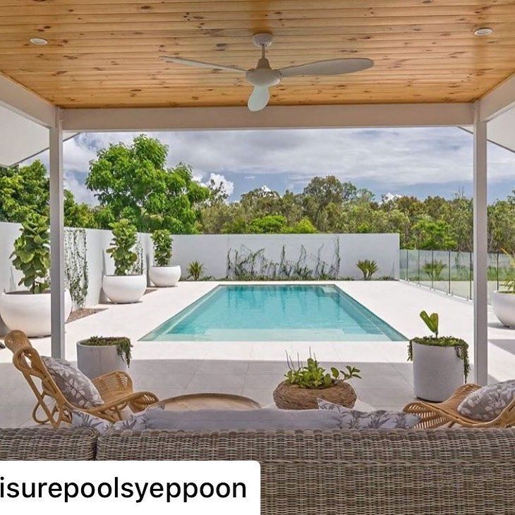 an outdoor living area with a pool and patio furniture