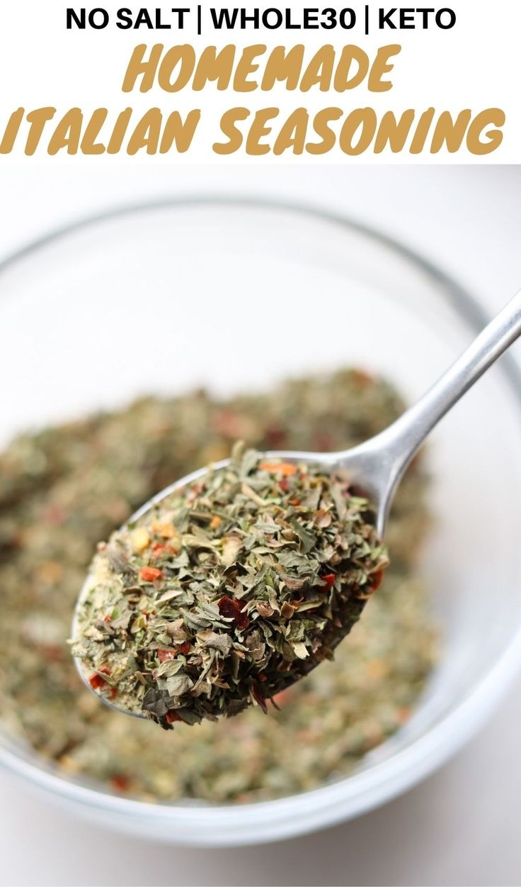 a spoon full of homemade italian seasoning in a glass bowl with text overlay