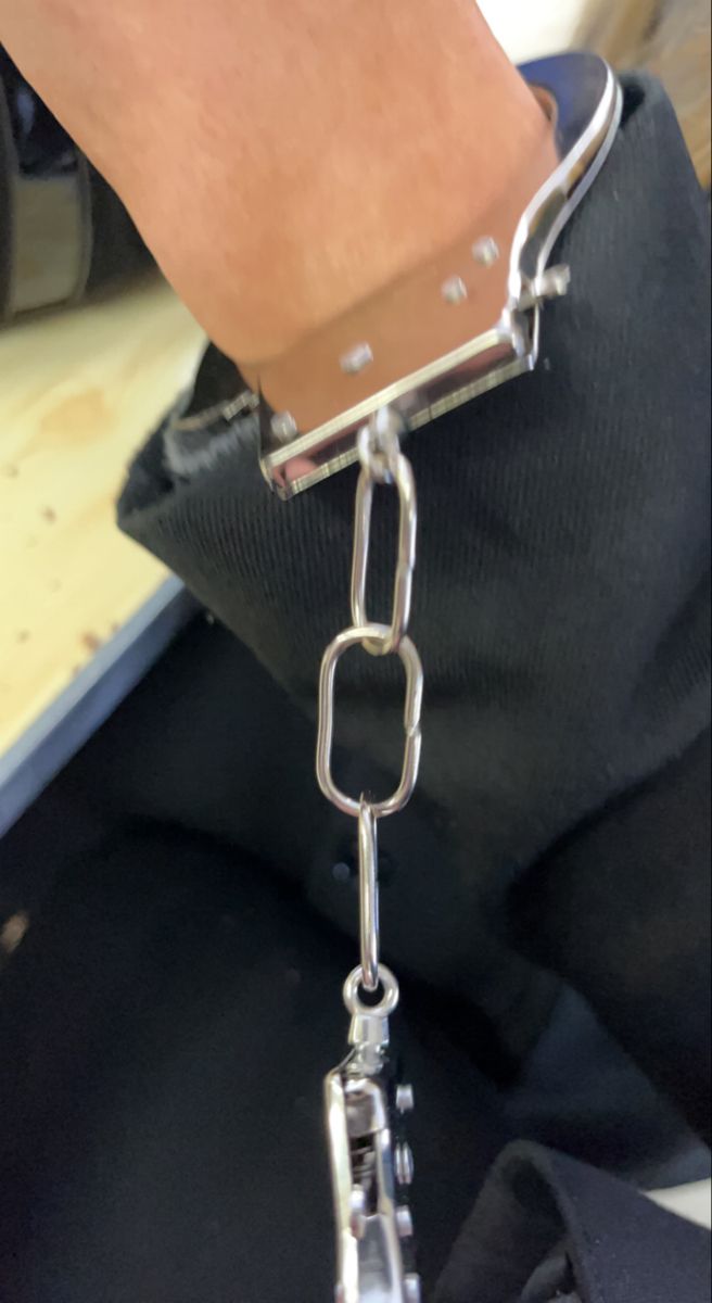 a person is holding onto a metal chain