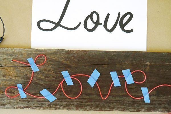 a wooden sign that says love on it