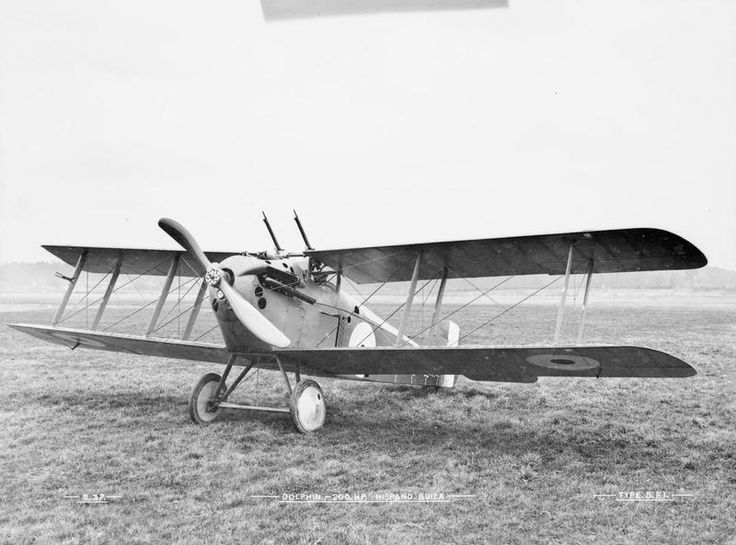 an old airplane sitting on top of a grass covered field