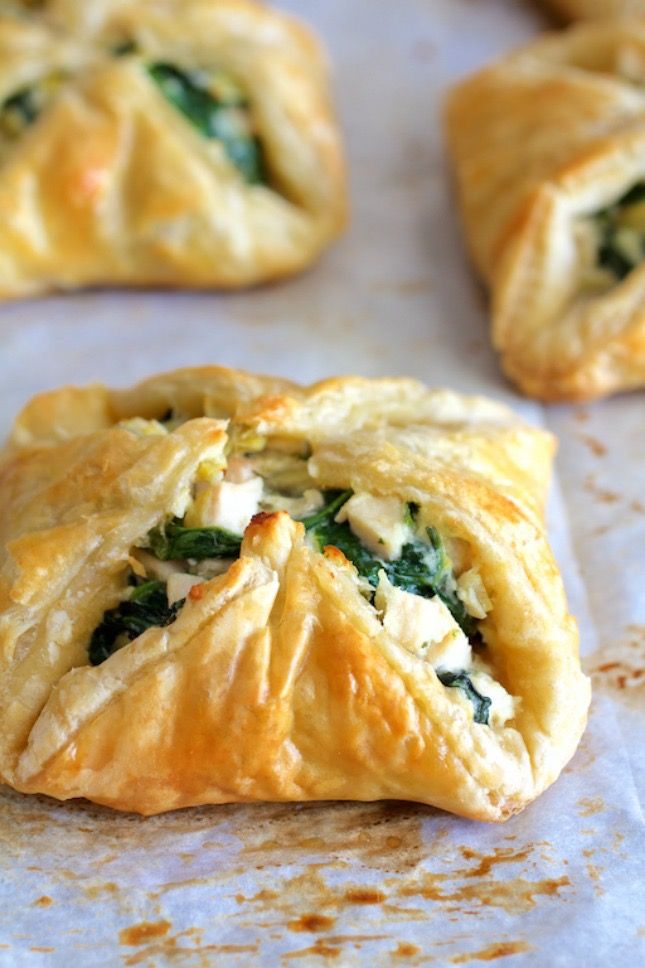 spinach and cheese pastries on a baking sheet