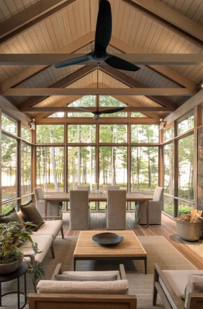 a living room filled with lots of furniture and a fire place in the middle of it