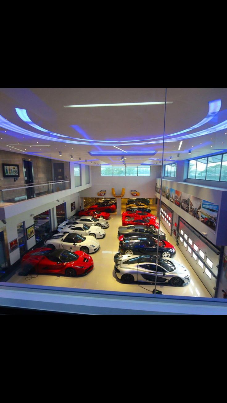 a car showroom filled with lots of different colored sports cars in it's display area