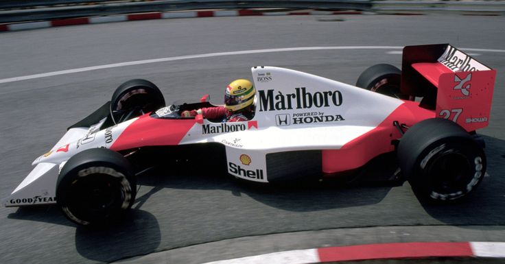 a man driving a white and red race car