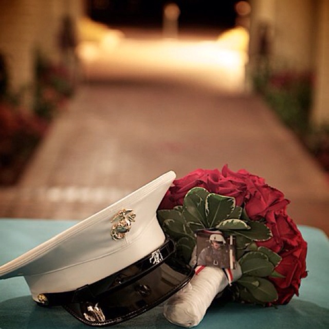 there is a hat and flowers on top of a blue table with the caption's name below it