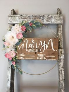 a wooden sign with flowers on it that says mary and the date, weight, time