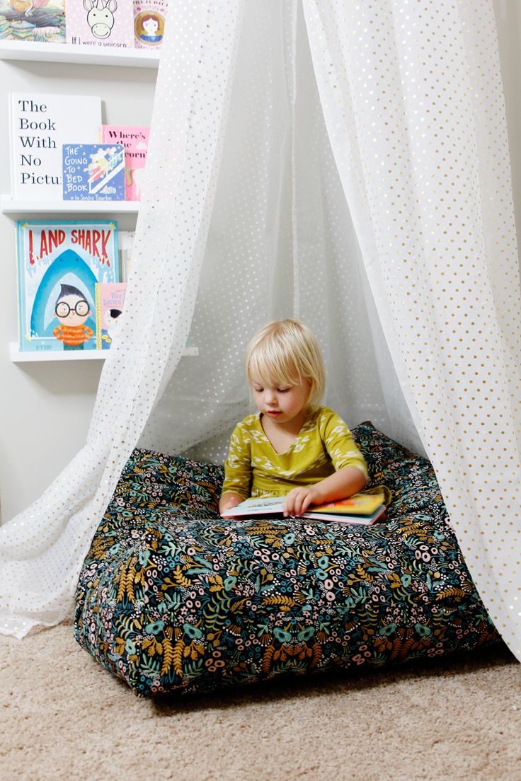 a little boy sitting on top of a dog bed