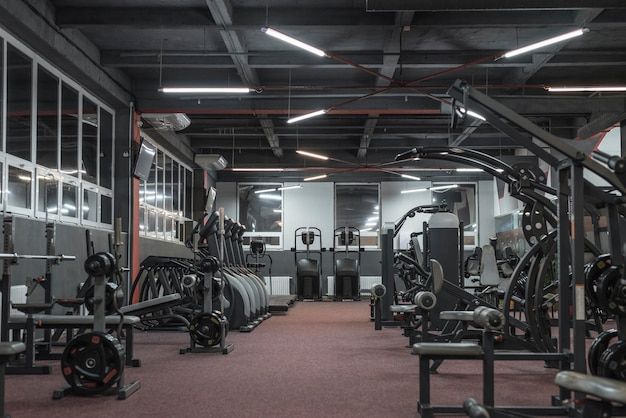 an empty gym with rows of exercise equipment