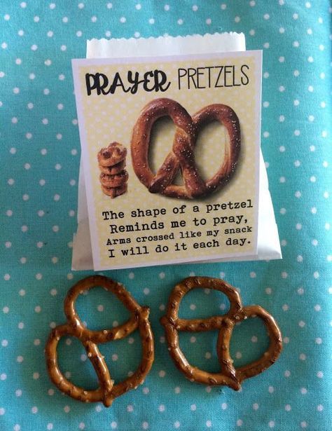 two pretzels sitting on top of a table next to a card with the words prayer pretzels