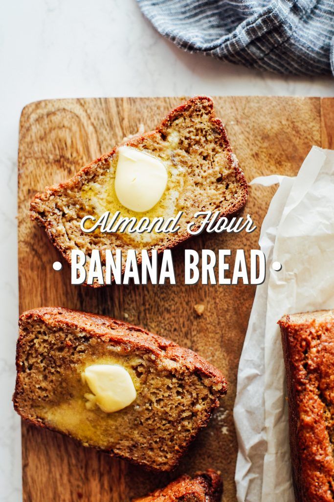 banana bread with butter on top sitting on a cutting board