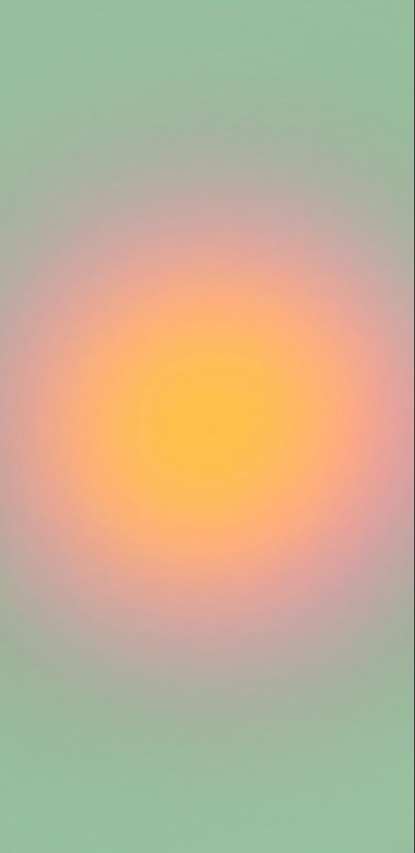 an orange and yellow circle is in the middle of a blurry background with green