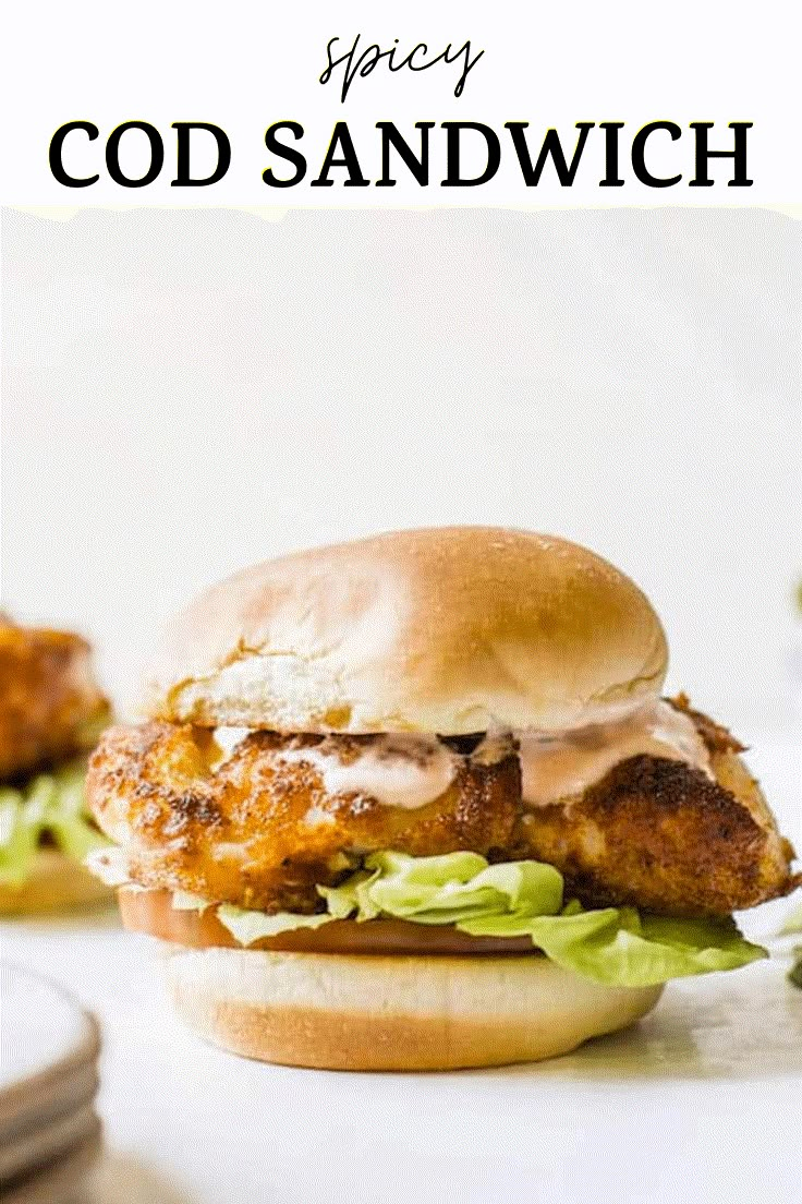 a chicken sandwich with lettuce and sauce on it