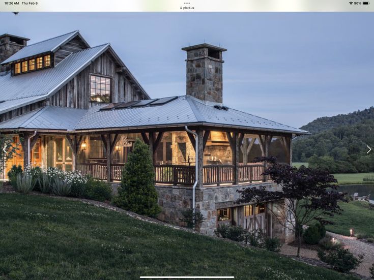 a large house sitting on top of a lush green hillside