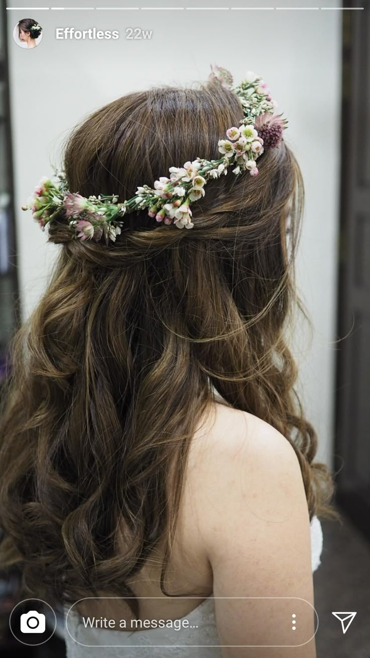 the back of a woman's head with flowers in her hair and texting