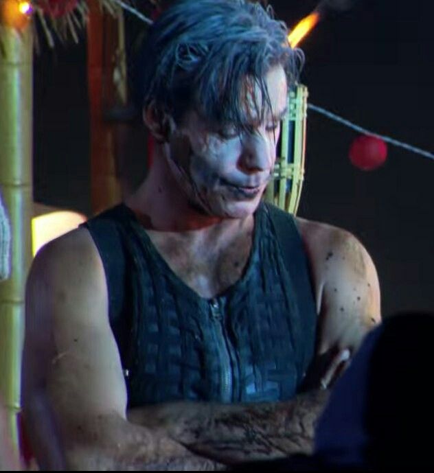 a man with white paint on his face and arm