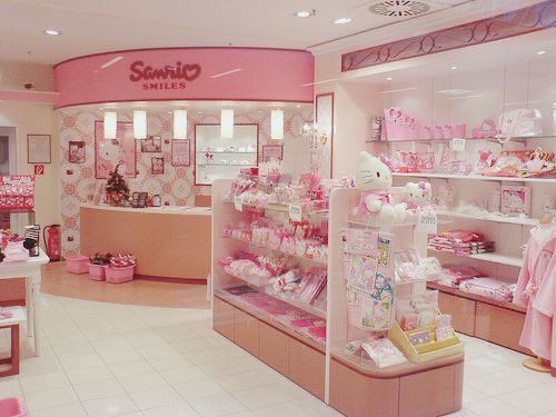 the inside of a store with hello kitty products on display and pink accessories for sale