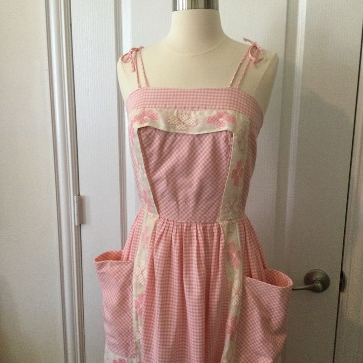 Vintage 60s Pink And White Gingham Dress. Thick Organza-Like Trim /Apron Detail. Fit And Flare Style With Gathered Skirt. Zips Up Center Back With A Nylon Zipper. Has Small Hole In Fabric On Front Bodice, See Pic. It Is Small And Is 1.75” Above Waistline. A Thick Belt Can Hide This. Zipper Has Some Loose Stitching, Looks Like It Was Redone At Some Point, It Can Benefit From Some Extra Stitches That I Have Not Done. Top Bodice Is Fully Lined With Same Gingham Fabric. Very Good Condition And Freshly Laundered! Measurements Bust 32-32.5” Side Seam To Side Seam Length 31.5” Top Side Seam To Hem Shoulder Straps Tie At Top Of Shoulder.. Spring Retro Gingham Dress, Retro Gingham Dress For Picnic, Retro Square Neck Dress For Picnic, Retro Cotton Vintage Dress For Picnic, Vintage Gingham Dresses With Square Neck, 1950s Style Gingham Dress For Picnic, Fitted Gingham Cottagecore Dress, Retro Gingham Vintage Dress, Retro Gingham Cotton Vintage Dress