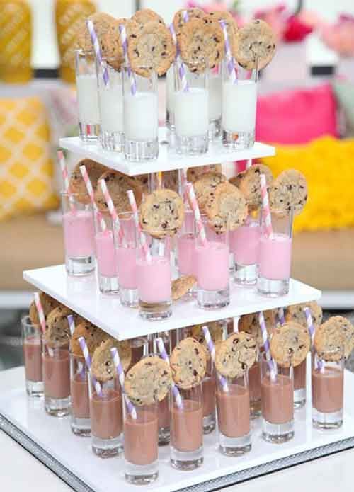 a dessert table with cookies and milk on it