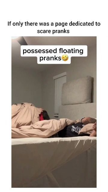 a man laying on top of a bed in a bedroom next to another person sleeping