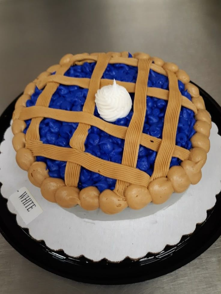 a blue and white cake on a black plate