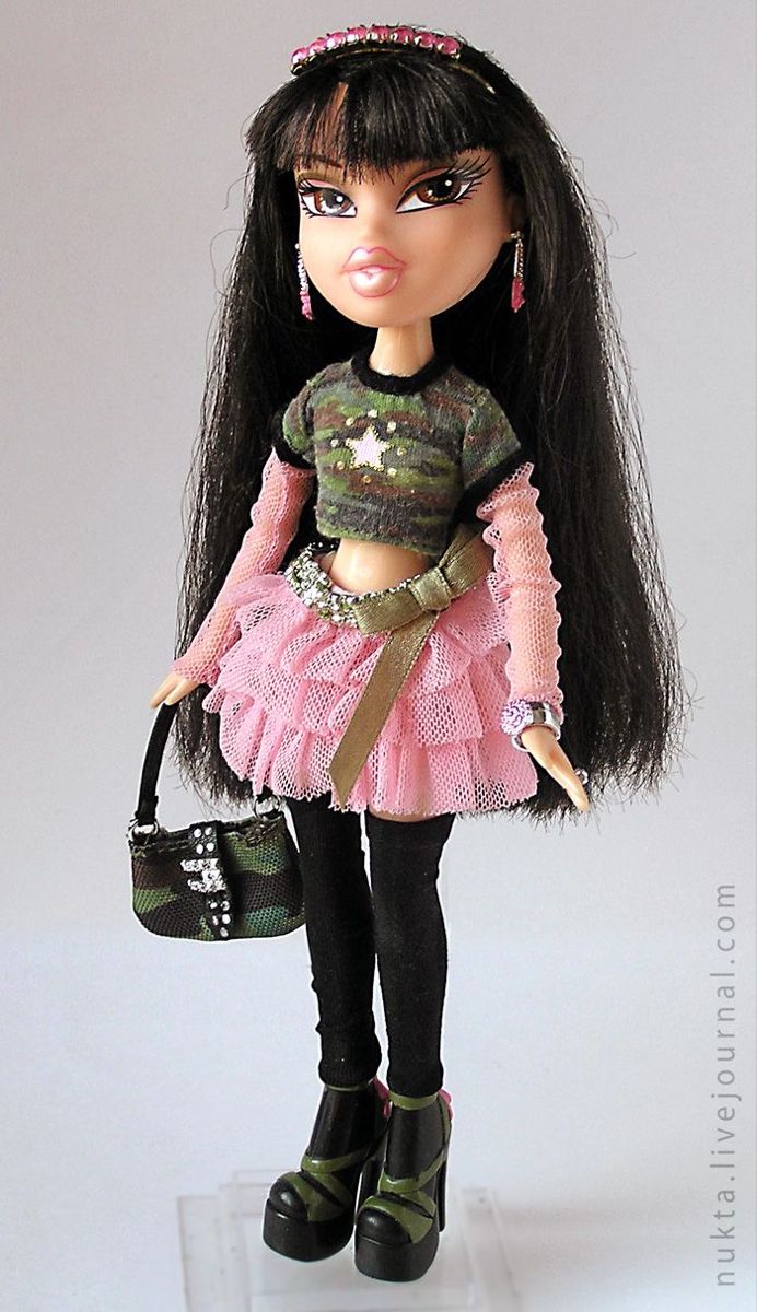 a doll with long black hair wearing a pink dress and holding a purse in her hand