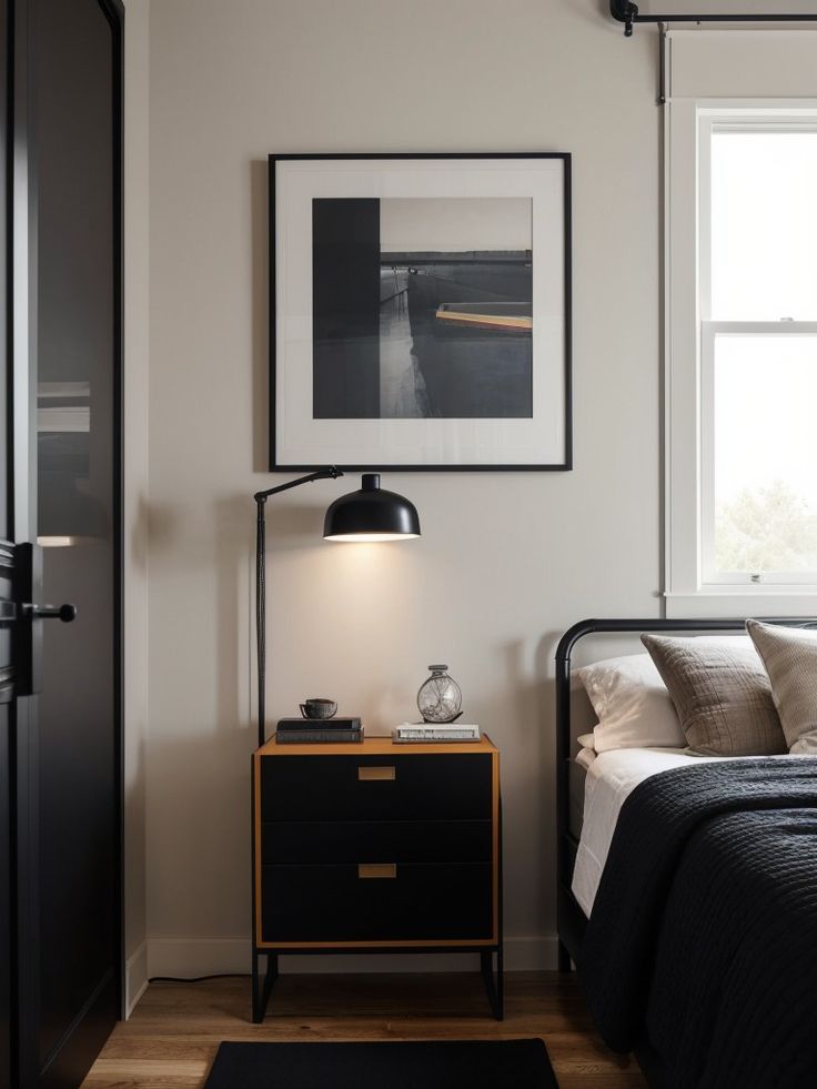 a bed room with a neatly made bed and a night stand next to a window